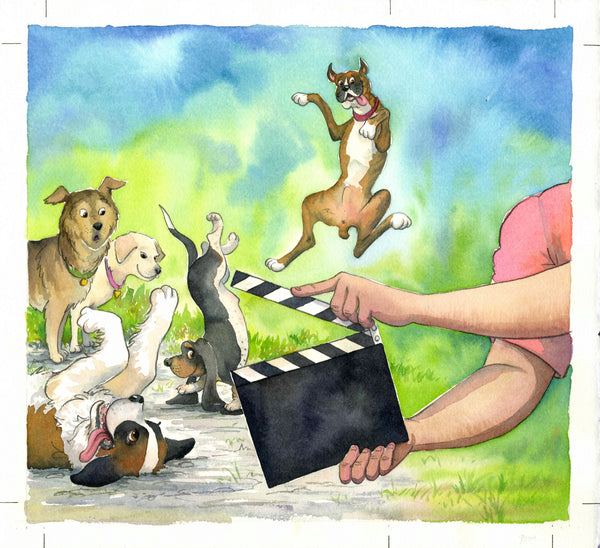 Two arms holding a movie scene board in front of five dogs doing antics.
