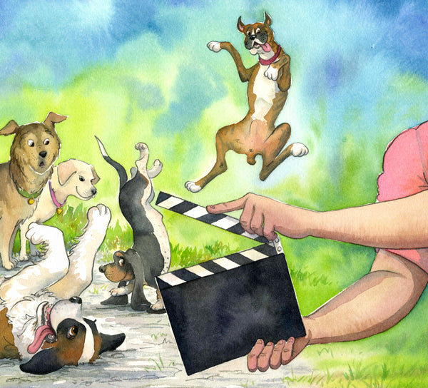 Two arms holding a movie scene board in front of five dogs doing antics.